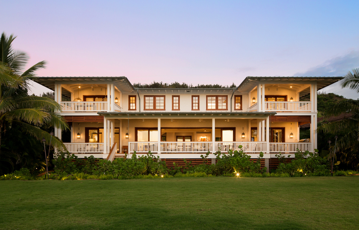 Interior Design, Furniture, Appliances, Landscaping, and exterior facade design of historic high-end luxury architectural large residence house with patio lanai balconies on top of a lush lawn on beach in Hawaii.